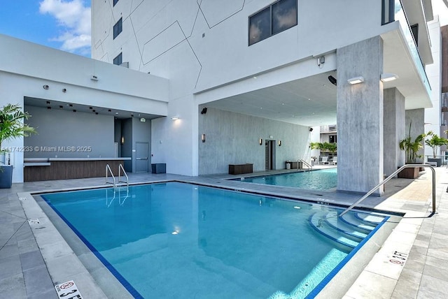 view of pool featuring a patio