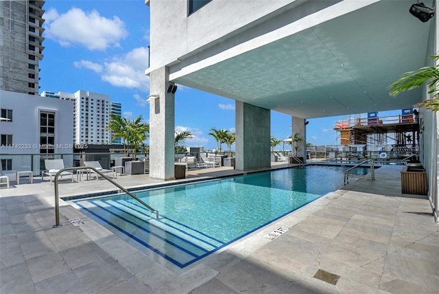 view of swimming pool featuring a patio