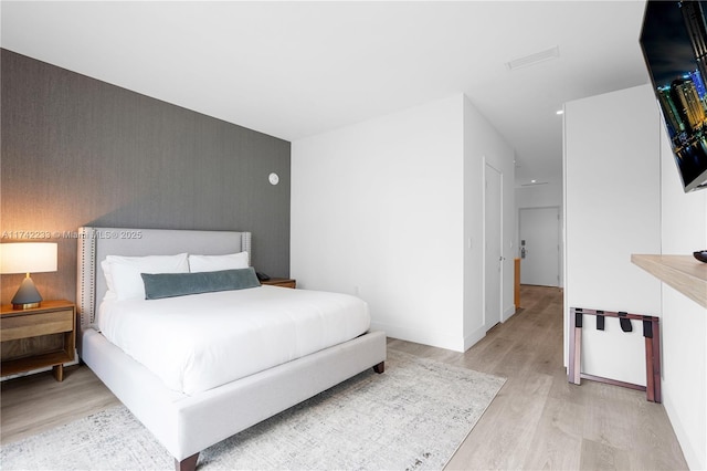 bedroom with light hardwood / wood-style floors