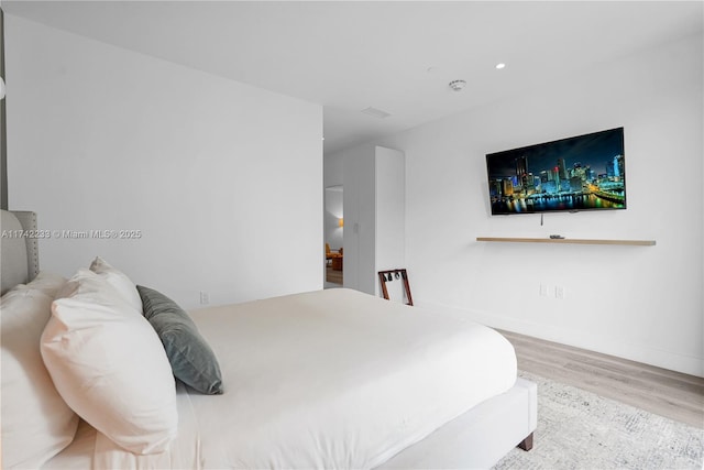 bedroom with light hardwood / wood-style floors