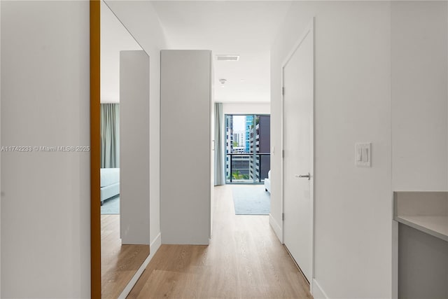 corridor with light wood-type flooring