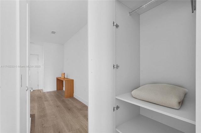 spacious closet featuring light hardwood / wood-style floors