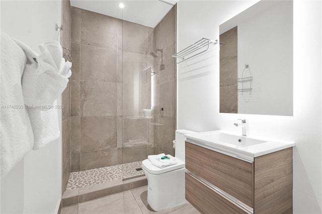 bathroom with vanity, toilet, and tiled shower