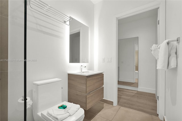 bathroom featuring vanity, tile patterned flooring, and toilet