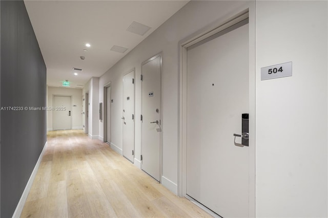 corridor with light hardwood / wood-style floors