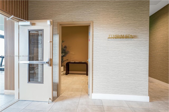 hall with light tile patterned floors