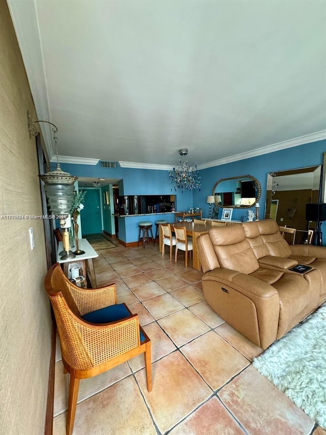 tiled living room featuring a notable chandelier and ornamental molding