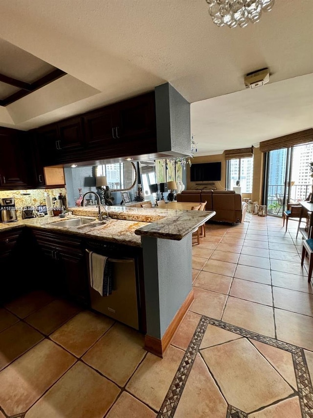 kitchen with sink, dark brown cabinets, light tile patterned floors, kitchen peninsula, and dishwasher