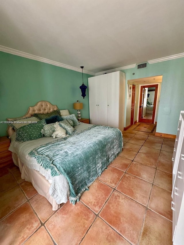 tiled bedroom featuring crown molding and a closet