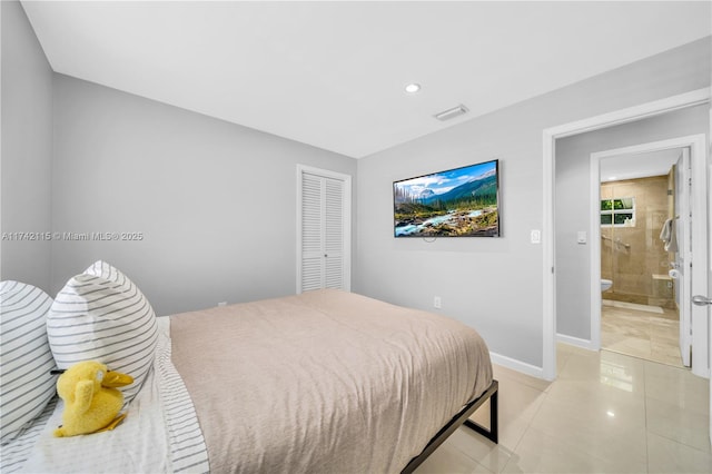 bedroom with light tile patterned flooring and a closet