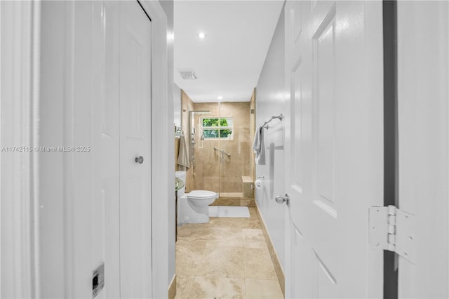 bathroom with walk in shower and toilet