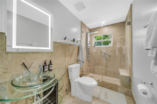 bathroom featuring walk in shower, tile walls, and toilet