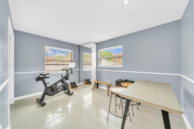 exercise area featuring tile patterned flooring and a wealth of natural light