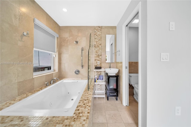 full bathroom featuring independent shower and bath, sink, tile walls, tile patterned flooring, and toilet