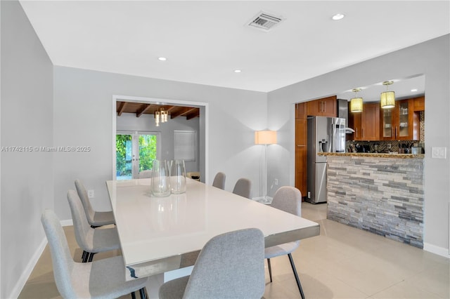 dining room featuring beamed ceiling