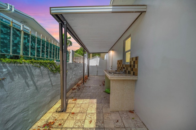 property exterior at dusk with a patio area