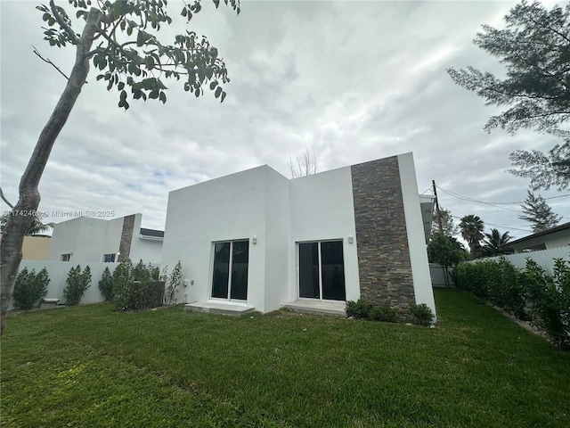 rear view of house with a yard