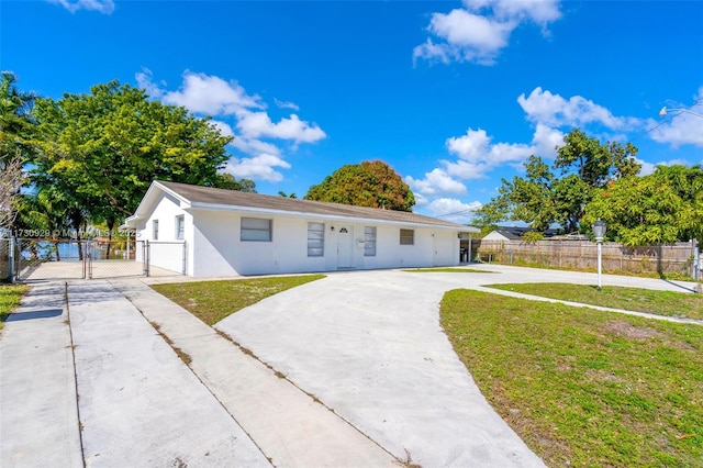 single story home featuring a front lawn