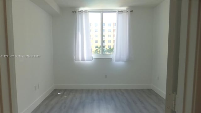 empty room with light hardwood / wood-style flooring