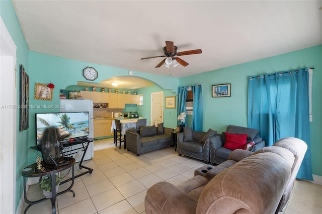 tiled living room featuring ceiling fan