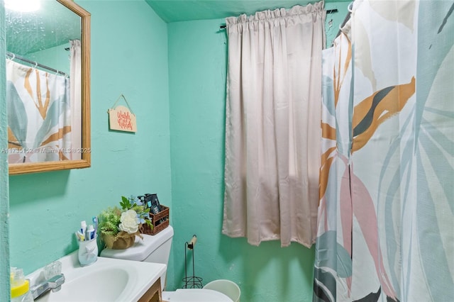 bathroom with vanity, toilet, and a shower with shower curtain