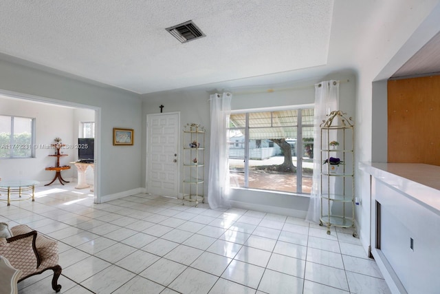 tiled entrance foyer featuring a textured ceiling