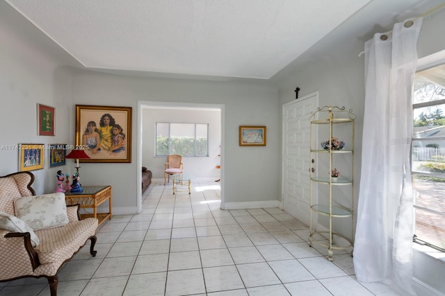 interior space with light tile patterned floors and a textured ceiling