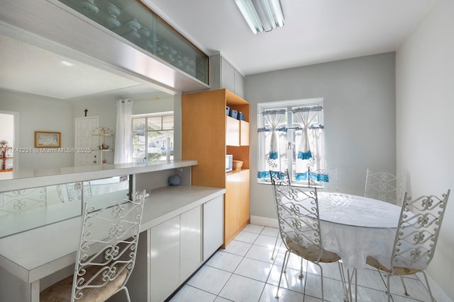 kitchen featuring white cabinetry and light tile patterned flooring