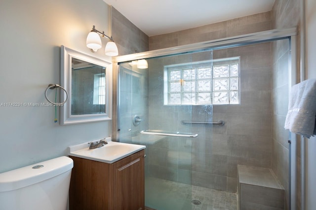 bathroom with vanity, toilet, and walk in shower