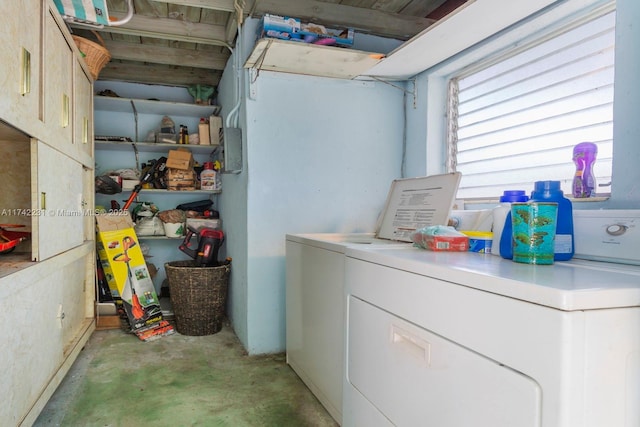 clothes washing area with cabinets and independent washer and dryer