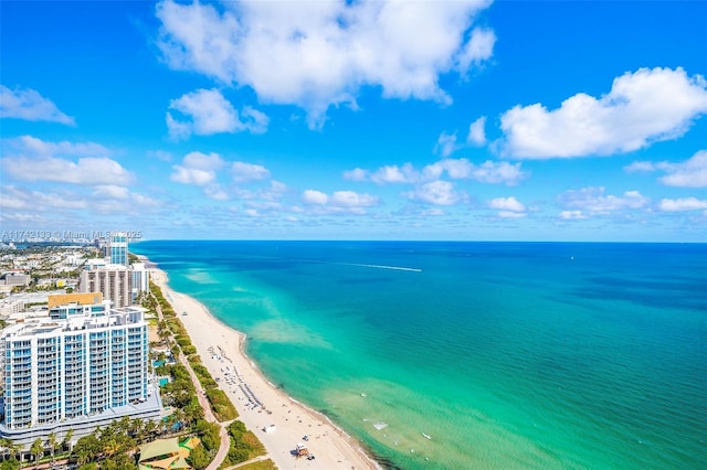 birds eye view of property with a view of the beach and a water view