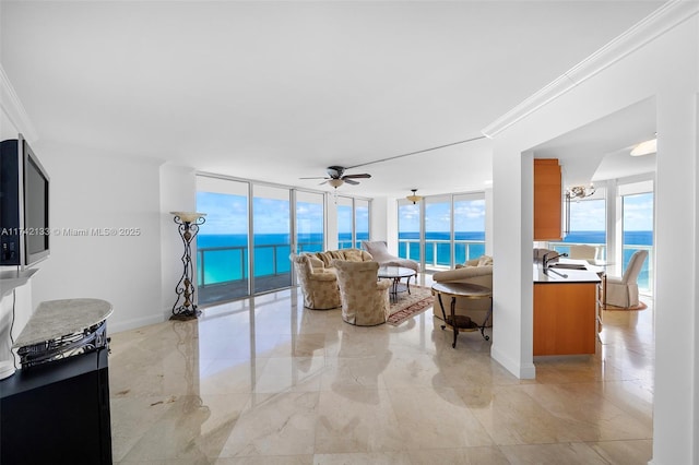 living room featuring expansive windows, crown molding, a water view, and ceiling fan