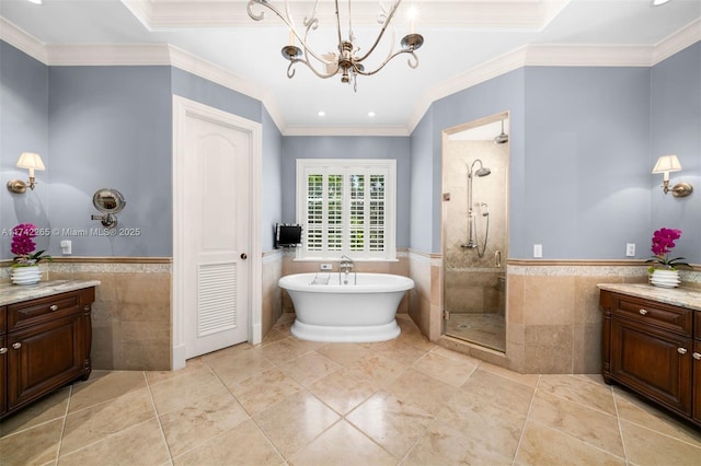 bathroom featuring vanity, ornamental molding, plus walk in shower, and tile walls