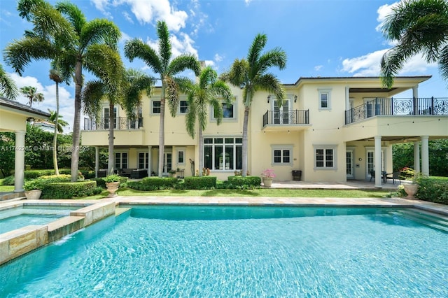 view of pool with a patio and an in ground hot tub