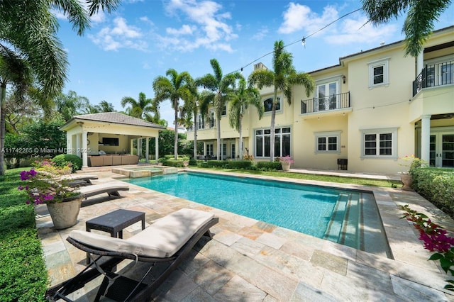 view of swimming pool featuring an in ground hot tub and a patio area