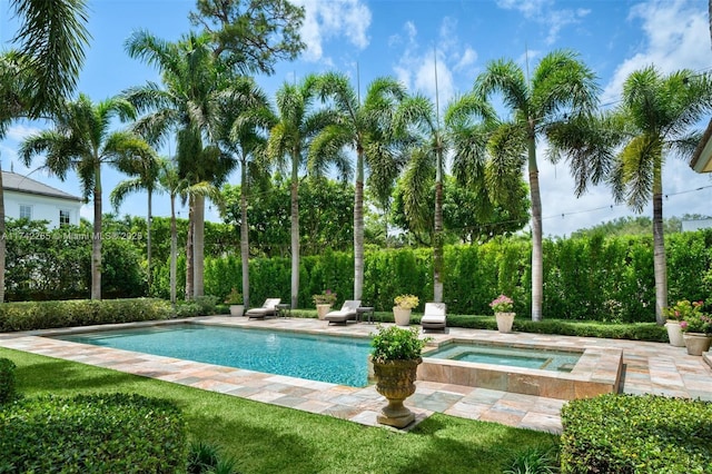 view of pool featuring a patio and an in ground hot tub