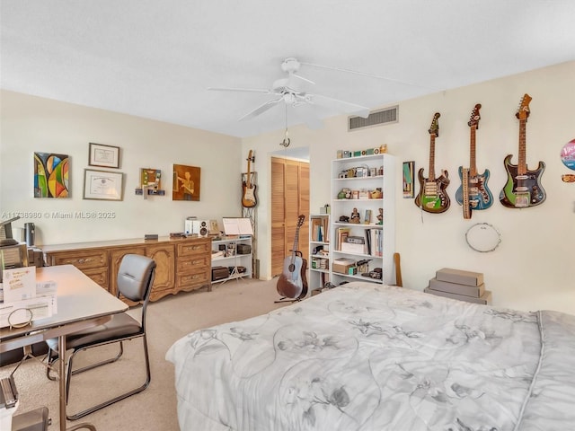 carpeted bedroom featuring a closet and ceiling fan