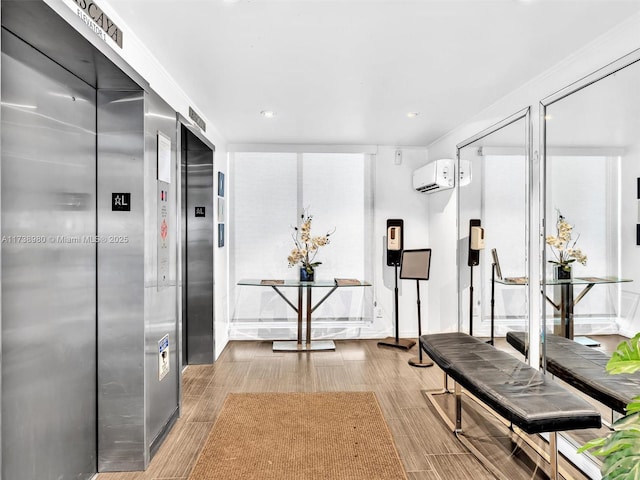 workout room with a wall unit AC and elevator