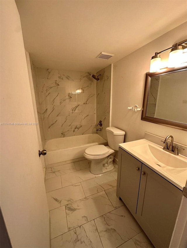 full bathroom with vanity, tiled shower / bath combo, and toilet