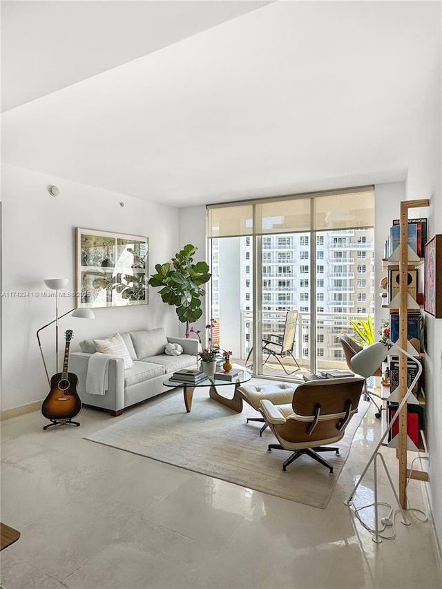 living room with concrete flooring and a wall of windows