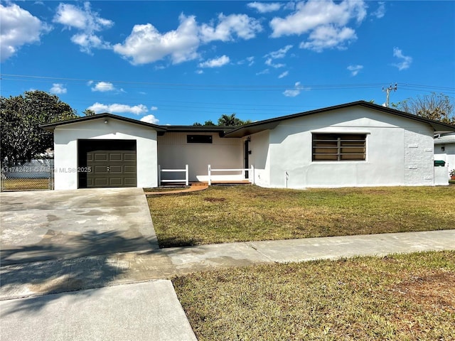 single story home featuring a garage and a front yard