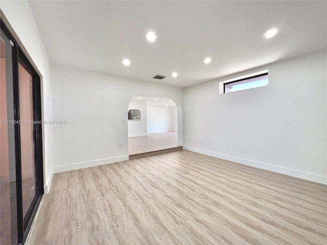 empty room with light hardwood / wood-style flooring