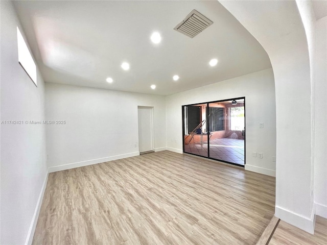 empty room with light hardwood / wood-style flooring