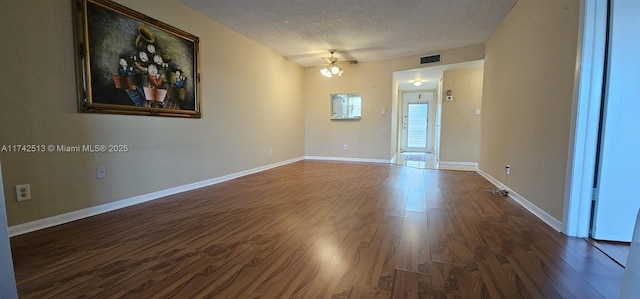 unfurnished room featuring dark hardwood / wood-style floors and a textured ceiling