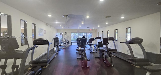 exercise room with a textured ceiling