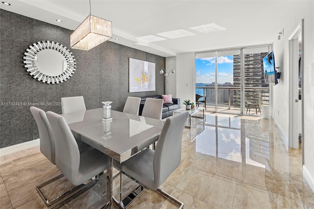 dining space featuring floor to ceiling windows