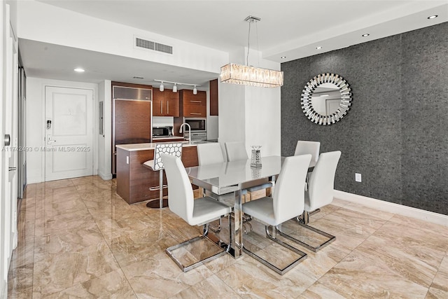 dining room featuring track lighting and a chandelier