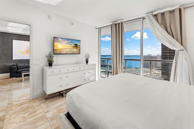 bedroom with floor to ceiling windows and access to exterior