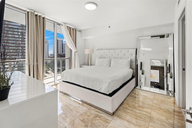 bedroom featuring floor to ceiling windows and access to exterior