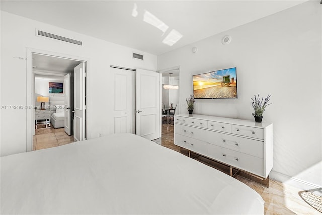 tiled bedroom featuring a closet